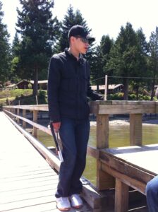Alex Jurgensen stands on the upper portion of a dock over water next to a wood railing.
