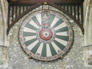 A medieval replica of King Arthur's legendary round table, hanging in Winchester Castle. The table features the Tudor Rose at its centre, with the outer design portraying Henry VIII as King Arthur on his throne, surrounded by 24 places, each bearing the name of one of the legendary Knights of the Round Table of King Arthur's court.